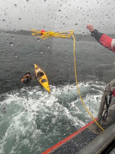 Parker Reef, Wash. — A Station Bellingham boat crew rescues a 45-year-old paddler after a wave capsized his kayak, Sept. 25, 2026. U.S. Coast Guard photo.
