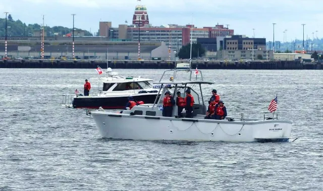 Seattle, Wash – Boat crew members escorting the USCGC Eagle. US Coast Guard photo.