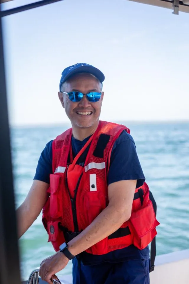 Bellingham Bay, Wash. — A crew member at the helm during a summer patrol. U.S. Coast Guard Auxiliary photo.