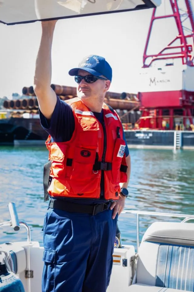 Bellingham, Wash. — A crew member signals from the deck along the waterfront. U.S. Coast Guard Auxiliary photo.