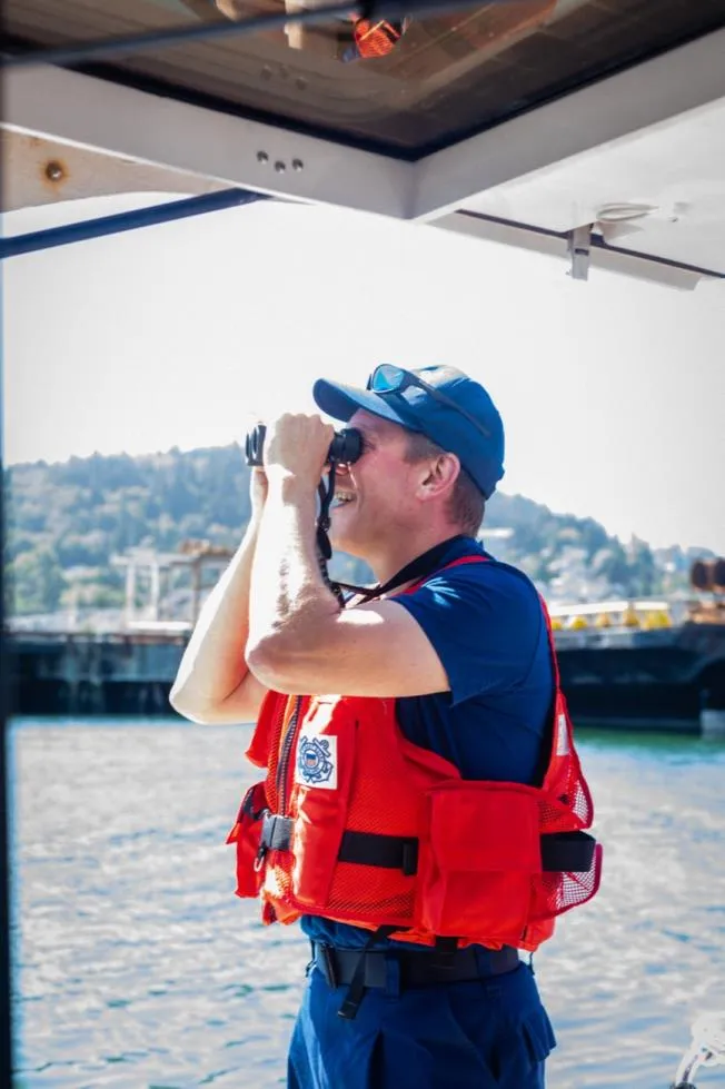 Bellingham Bay, Wash. — A crew member scans the water during a summer patrol. U.S. Coast Guard Auxiliary photo.